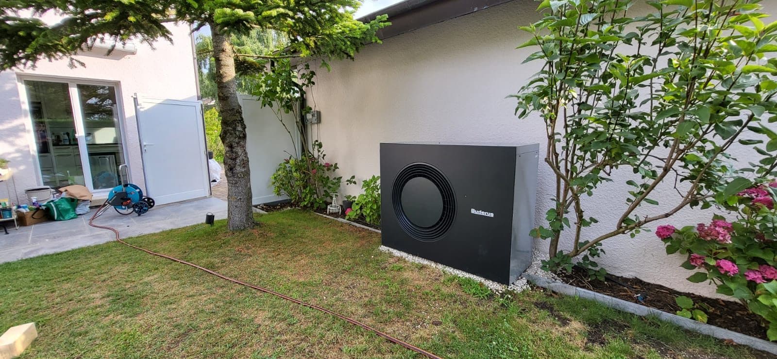 Air-to-water heat pump installed in the garden of a villa in Coppet, Vaud