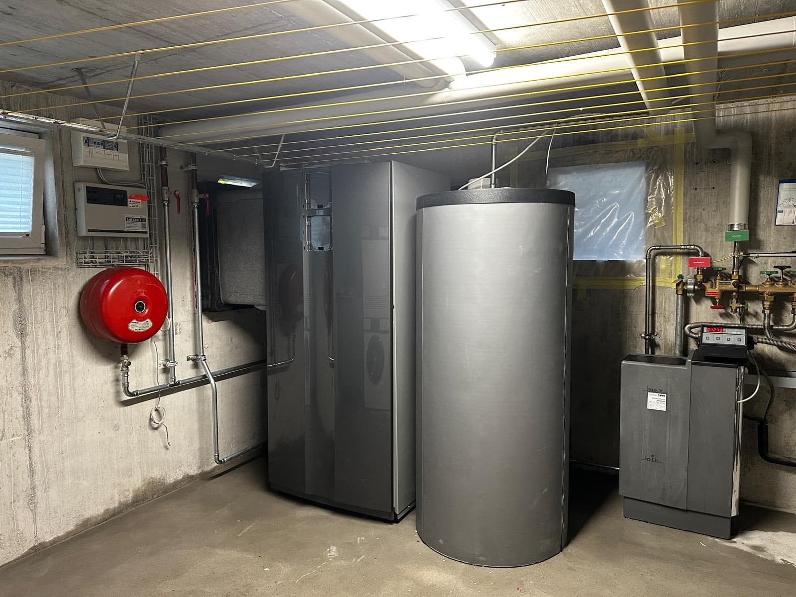 Plant room with a heat pump and hot water tank in Altendorf, Schwyz